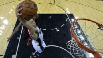 Jun 5, 2014; San Antonio, TX, USA; San Antonio Spurs guard Danny Green (4) dunks the ball against Miami Heat forward Rashard Lewis (9) during the fourth quarter in game one of the 2014 NBA Finals at AT&T Center. Mandatory Credit: Soobum Im-USA TODAY Sports