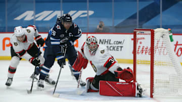 WINNIPEG, MANITOBA - MAY 08: Blake Wheeler #26 of the Winnipeg Jets battles for a puck with Artem Zub #2 and Filip Gustavsson #32 of the Ottawa Senators during second period NHL action on May 8, 2021 at Bell MTS Place in Winnipeg, Manitoba, Canada. (Photo by Jason Halstead/Getty Images)