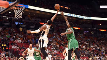 Dec 18, 2016; Miami, FL, USA; Miami Heat center Hassan Whiteside (21) and Boston Celtics forward Amir Johnson (90) reach for a rebound during the second half at American Airlines Arena. Mandatory Credit: Steve Mitchell-USA TODAY Sports
