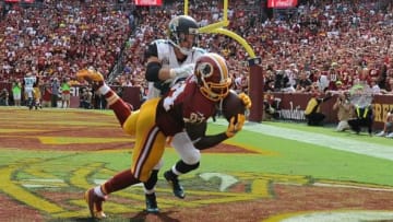Sep 14, 2014; Landover, MD, USA; Washington Redskins tight end Niles Paul (84) chatches a touchdown as Jacksonville Jaguars strong safety Chris Prosinski (42) defends during the second half at FedEx Field. Mandatory Credit: Brad Mills-USA TODAY Sports