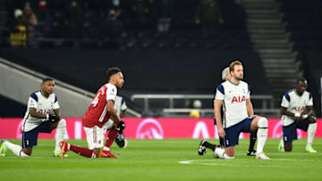 LONDON, ENGLAND - DECEMBER 06: Pierre-Emerick Aubameyang of Arsenal and Harry Kane and Steven Bergwijn of Tottenham Hotspur take a knee in support of the Black Lives Matter movement during the Premier League match between Tottenham Hotspur and Arsenal at Tottenham Hotspur Stadium on December 06, 2020 in London, England. A limited number of fans (2000) are welcomed back to stadiums to watch elite football across England. This was following easing of restrictions on spectators in tiers one and two areas only. (Photo by Glyn Kirk - Pool/Getty Images)