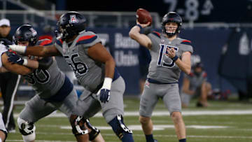 TUCSON, ARIZONA - DECEMBER 05: Quarterback Will Plummer #15 of the Arizona Wildcats throws a pass against the Colorado Buffaloes during the first half of the PAC-12 football game at Arizona Stadium on December 05, 2020 in Tucson, Arizona. (Photo by Ralph Freso/Getty Images)