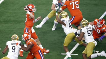ARLINGTON, TEXAS - DECEMBER 29: Trevor Lawrence #16 of the Clemson Tigers looks to pass in the first half against Julian Okwara #42 of the Notre Dame Fighting Irish during the College Football Playoff Semifinal Goodyear Cotton Bowl Classic at AT&T Stadium on December 29, 2018 in Arlington, Texas. (Photo by Tim Warner/Getty Images)