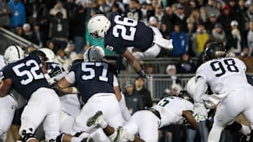 Nov 26, 2016; University Park, PA, USA; Penn State Nittany Lions running back Saquon Barkley (26) jumps into the end zone for a touchdown during the second quarter against the Michigan State Spartans at Beaver Stadium. Mandatory Credit: Matthew O