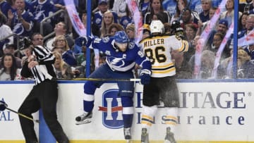 TAMPA, FL - APRIL 30: Tampa Bay Lightning center Steven Stamkos (91) finishes his check on Boston Bruins defender Kevan Miller (86) during the second period of an NHL Stanley Cup Eastern Conference Playoffs game between the Boston Bruins and the Tampa Bay Lightning on April 30, 2018, at Amalie Arena in Tampa, FL. (Photo by Roy K. Miller/Icon Sportswire via Getty Images)