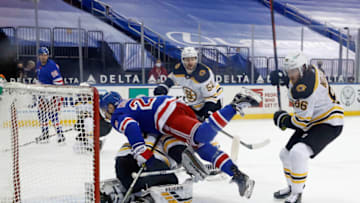 Feb 10, 2021; New York, New York, USA; Chris Kreider #20 of the New York Rangers falls over Tuukka Rask #40 of the Boston Bruins during the third period at Madison Square Garden. Mandatory Credit: Bruce Bennett/Pool Photo-USA TODAY Sports