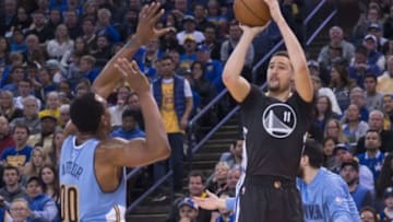 January 2, 2016; Oakland, CA, USA; Golden State Warriors guard Klay Thompson (11) shoots the basketball against Denver Nuggets forward Darrell Arthur (00) during the fourth quarter at Oracle Arena. The Warriors defeated the Nuggets 111-108 in overtime. Mandatory Credit: Kyle Terada-USA TODAY Sports