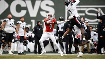Cincinnati Bearcats safety Ja'von Hicks intercepts a pass against the Louisville Cardinals during the Fenway Bowl. USA Today.