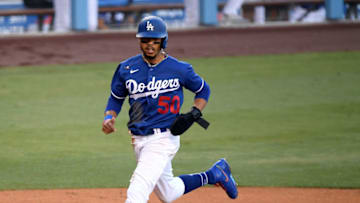 LOS ANGELES, CALIFORNIA - JULY 19: Mookie Betts #50 of the Los Angeles Dodgers reacts as he scores a run on a sacrifice fly, to take a 5-1 lead over the Arizona Diamondbacks during the third inning, in a preseason game during the coronavirus (COVID-19) pandemic at Dodger Stadium on July 19, 2020 in Los Angeles, California. (Photo by Harry How/Getty Images)