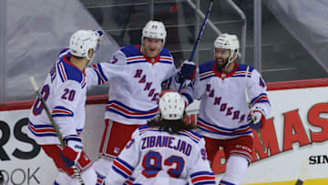 Mar 6, 2021; Newark, New Jersey, USA; New York Rangers players celebrate a goal by defenseman Adam Fox (23) during the first period against the New Jersey Devils at Prudential Center. Mandatory Credit: Ed Mulholland-USA TODAY Sports