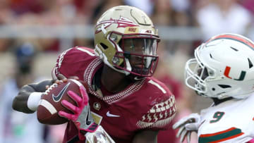 TALLAHASSEE OCTOBER 7: Quarterback James Blackman #1 of the Florida State Seminoles scrambles away from defensive lineman Chad Thomas #9 of the Miami Hurricanes during the second half of an NCAA football game at Doak S. Campbell Stadium on October 7, 2017 in Tallahassee, Florida. (Photo by Butch Dill/Getty Images)