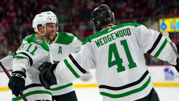 Mar 24, 2022; Raleigh, North Carolina, USA; Dallas Stars goaltender Scott Wedgewood (41) and center Luke Glendening (11) celebrate there win against the Carolina Hurricanes at PNC Arena. Mandatory Credit: James Guillory-USA TODAY Sports