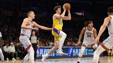 LOS ANGELES, CALIFORNIA - MAY 22: Austin Reaves #15 of the Los Angeles Lakers passes in front of Nikola Jokic #15 of the Denver Nuggets during the first quarter in game four of the Western Conference Finals at Crypto.com Arena on May 22, 2023 in Los Angeles, California. NOTE TO USER: User expressly acknowledges and agrees that, by downloading and or using this photograph, User is consenting to the terms and conditions of the Getty Images License Agreement. (Photo by Harry How/Getty Images)