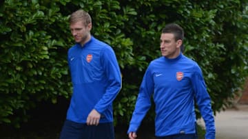 ST ALBANS, ENGLAND - MARCH 10: Per Mertesacker and Laurent Koscielny look on during the Arsenal training session at London Colney on March 10, 2014 in St Albans, England. (Photo by Michael Regan/Getty Images)