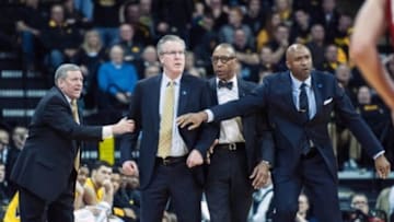Feb 24, 2016; Iowa City, IA, USA; Iowa Hawkeyes head coach Fran McCaffery is held back by his assistants as he questions a call against the Wisconsin Badgers during the first half at Carver-Hawkeye Arena. Mandatory Credit: Jeffrey Becker-USA TODAY Sports
