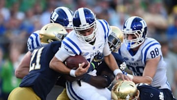 SOUTH BEND, IN - SEPTEMBER 24: Daniel Jones #17 of the Duke Blue Devils is stopped by Te'von Coney #4 and Jalen Elliott #21 of the Notre Dame Fighting Irish during the fourth quarter of a game at Notre Dame Stadium on September 24, 2016 in South Bend, Indiana. (Photo by Stacy Revere/Getty Images)
