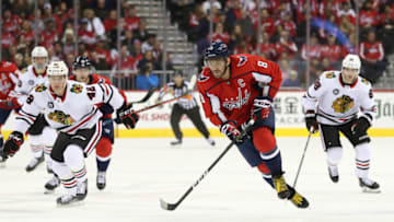 WASHINGTON, DC - NOVEMBER 21: Alex Ovechkin #8 of the Washington Capitals skates with the puck in front of Gustav Forsling #42 of the Chicago Blackhawks during the second period at Capital One Arena on November 21, 2018 in Washington, DC. (Photo by Will Newton/Getty Images)