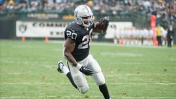 Oct 27, 2013; Oakland, CA, USA; Oakland Raiders running back Darren McFadden (20) rushes for a touchdown against the Pittsburgh Steelers during the second quarter at O.co Coliseum. Mandatory Credit: Ed Szczepanski-USA TODAY Sports