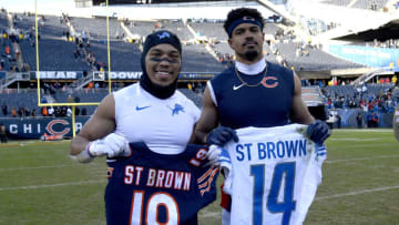 CHICAGO, ILLINOIS - NOVEMBER 13: Amon-Ra St. Brown #14 of the Detroit Lions and Equanimeous St. Brown #19 of the Chicago Bears pose with each others jerseys after Detroit's 31-30 win at Soldier Field on November 13, 2022 in Chicago, Illinois. (Photo by Quinn Harris/Getty Images)