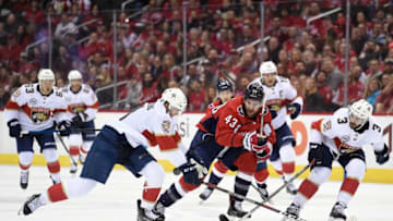 WASHINGTON, DC - FEBRUARY 09: Tom Wilson #43 of the Washington Capitals battles for the puck against Jonathan Huberdeau #11 and Keith Yandle #3 of the Florida Panthers in the first period at Capital One Arena on February 9, 2019 in Washington, DC. (Photo by Patrick McDermott/NHLI via Getty Images)