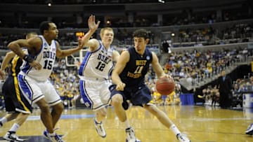 WASHINGTON - MARCH 22: Joe Alexander #11 of the West Virginia Mountaineers drives to the hoop during a NCAA Men's Basketball 2nd round game against Kyle Singler #21 and Gerald Henderson #15 of the Duke Blue Devils at Verizon Center on March 22, 2008 in Washington, D.C..(Photo by G Fiume/Getty Images)