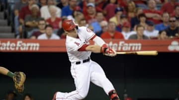 Jun 11, 2014; Anaheim, CA, USA; Los Angeles Angels right fielder Collin Cowgill (7) hits a single against the Oakland Athletics during the third inning at Angel Stadium of Anaheim. Mandatory Credit: Richard Mackson-USA TODAY Sports