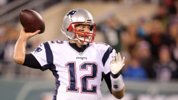 Nov 27, 2016; East Rutherford, NJ, USA; New England Patriots quarterback Tom Brady (12) throws a touchdown pass against the New York Jets after fumbling the snap during the second quarter at MetLife Stadium. Mandatory Credit: Brad Penner-USA TODAY Sports