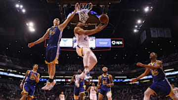 PHOENIX, ARIZONA - FEBRUARY 12: Elie Okobo #2 of the Phoenix Suns drives to the basket past Alen Smailagic #6 of the Golden State Warriors during the NBA game at Talking Stick Resort Arena on February 12, 2020 in Phoenix, Arizona. The Suns defeated the Warriors 112-106. NOTE TO USER: User expressly acknowledges and agrees that, by downloading and or using this photograph, user is consenting to the terms and conditions of the Getty Images License Agreement. Mandatory Copyright Notice: Copyright 2020 NBAE. (Photo by Christian Petersen/Getty Images)