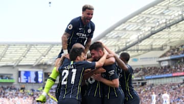 BRIGHTON, ENGLAND - MAY 12: Aymeric Laporte of Manchester City celebrates with teammates after scoring his team's second goal as Kyle Walker of Manchester City jumps on top during the Premier League match between Brighton & Hove Albion and Manchester City at American Express Community Stadium on May 12, 2019 in Brighton, United Kingdom. (Photo by Mike Hewitt/Getty Images)