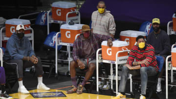 LOS ANGELES, CA - APRIL 15: Injured Los Angeles Lakers players Andre Drummond #2, LeBron James #23, Jared Dudley #10, Anthony Davis #3, and Markieff Morris #88 of the Los Angeles Lakers follow the action from the bench during the basketball game game against the Boston Celtics at Staples Center on April 15, 2021 in Los Angeles, California. NOTE TO USER: User expressly acknowledges and agrees that, by downloading and or using this photograph, User is consenting to the terms and conditions of the Getty Images License Agreement. (Photo by Kevork Djansezian/Getty Images)