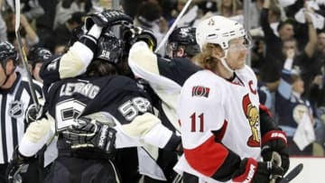 May 24, 2013; Pittsburgh, PA, USA; Ottawa Senators right wing Daniel Alfredsson (11) reacts as the Pittsburgh Penguins celebrate a goal by left wing James Neal (18) during the second period in game five of the second round of the 2013 Stanley Cup Playoffs at the CONSOL Energy Center. Mandatory Credit: Charles LeClaire-USA TODAY Sports