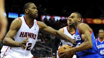 Mar 31, 2014; Atlanta, GA, USA; Philadelphia 76ers guard Elliot Williams (25) drives past Atlanta Hawks forward Elton Brand (42) during the first half at Philips Arena. Mandatory Credit: Dale Zanine-USA TODAY Sports