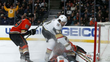 ANAHEIM, CA - DECEMBER 27: John Gibson #36 of the Anaheim Ducks makes a save against Mark Stone #61 of the Vegas Golden Knights with help from Sam Carrick #39 during the game at Honda Center on December 27, 2019 in Anaheim, California. (Photo by Debora Robinson/NHLI via Getty Images)