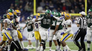 Dec 26, 2019; Detroit, Michigan, USA; Pittsburgh Panthers defensive back Paris Ford (12) grabs the facemask of Eastern Michigan Eagles offensive lineman Sidy Sow (62) during the fourth quarter at Ford Field. Mandatory Credit: Raj Mehta-USA TODAY Sports