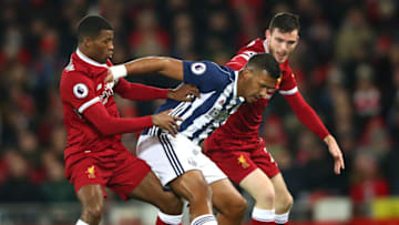 LIVERPOOL, ENGLAND - DECEMBER 13: Jose Salomon Rondon of West Bromwich Albion is challenged by Georginio Wijnaldum of Liverpool and Andy Robertson of Liverpool during the Premier League match between Liverpool and West Bromwich Albion at Anfield on December 13, 2017 in Liverpool, England. (Photo by Clive Brunskill/Getty Images)