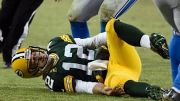 Dec 28, 2014; Green Bay, WI, USA; Green Bay Packers quarterback Aaron Rodgers (12) lies on the ground after an injury in the second quarter during the game against the Detroit Lions at Lambeau Field. Mandatory Credit: Benny Sieu-USA TODAY Sports