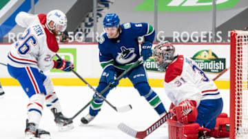VANCOUVER, BC - JANUARY 20: Goalie Carey Price #31 of the Montreal Canadiens keeps his eye on the puck after making a save while teammate Jeff Petry #26 keeps Brock Boeser #6 of the Vancouver Canucks in check during NHL hockey action at Rogers Arena on January 20, 2021 in Vancouver, Canada. (Photo by Rich Lam/Getty Images)