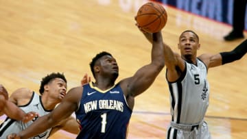 NEW ORLEANS, LOUISIANA - DECEMBER 27: Zion Williamson #1 of the New Orleans Pelicans pulls down a rebound against Dejounte Murray #5 of the San Antonio Spurs during a game at Smoothie King Center on December 27, 2020 in New Orleans, Louisiana. NOTE TO USER: User expressly acknowledges and agrees that, by downloading and or using this photograph, User is consenting to the terms and conditions of the Getty Images License Agreement. (Photo by Sean Gardner/Getty Images)