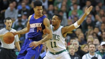 Nov 17, 2014; Boston, MA, USA; Phoenix Suns guard Gerald Green (14) controls the ball while Boston Celtics guard Evan Turner (11) defends during the second half at TD Garden. Mandatory Credit: Bob DeChiara-USA TODAY Sports