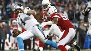 Jan 24, 2016; Charlotte, NC, USA; Carolina Panthers quarterback Cam Newton (1) runs the ball past Arizona Cardinals defense during the fourth quarter in the NFC Championship football game at Bank of America Stadium. The Panthers won 49-15. Mandatory Credit: Jason Getz-USA TODAY Sports