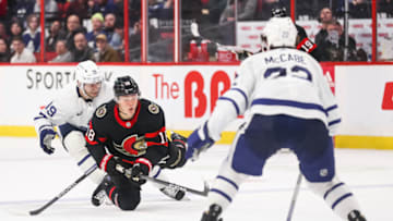 OTTAWA, CANADA - MARCH 18: Tim Stützle #18 of the Ottawa Senators falls while skating with the puck against Calle Jarnkrok #19 of the Toronto Maple Leafs during the second period at Canadian Tire Centre on March 18, 2023 in Ottawa, Ontario, Canada. (Photo by Chris Tanouye/Freestyle Photography/Getty Images)