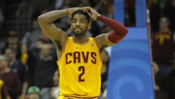 Apr 5, 2014; Cleveland, OH, USA; Cleveland Cavaliers guard Kyrie Irving (2) reacts after missing a shot in overtime against the Charlotte Bobcats at Quicken Loans Arena. Mandatory Credit: David Richard-USA TODAY Sports