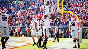 JACKSONVILLE, FLORIDA - OCTOBER 30: James Cook #4 of the Georgia Bulldogs celebrates with Justin Shaffer #54 after scoring a touchdown during the second quarter of a game against the Florida Gators at TIAA Bank Field on October 30, 2021 in Jacksonville, Florida. (Photo by James Gilbert/Getty Images)