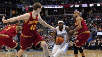 Jan 17, 2014; Denver, CO, USA; Denver Nuggets point guard Ty Lawson (3) drives to the net against Cleveland Cavaliers center Tyler Zeller (40) and point guard Jarrett Jack (1) in the first quarter at the Pepsi Center. Mandatory Credit: Isaiah J. Downing-USA TODAY Sports