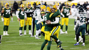GREEN BAY, WISCONSIN - DECEMBER 06: Aaron Rodgers #12 of the Green Bay Packers celebrates with teammate Tim Boyle #8 following a nine yard touchdown pass during the third quarter of their game against the Philadelphia Eagles at Lambeau Field on December 06, 2020 in Green Bay, Wisconsin. The touchdown marks Rodgers' 400th career touchdown pass. (Photo by Dylan Buell/Getty Images)