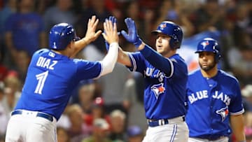 BOSTON, MA - JULY 13: Justin Smoak #14 high fives Aledmys Diaz #1 of the Toronto Blue Jays after hitting a two-run home run in the ninth inning of a game against the Boston Red Sox at Fenway Park on July 13, 2018 in Boston, Massachusetts. (Photo by Adam Glanzman/Getty Images)