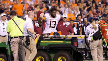 CHARLOTTESVILLE, VA - SEPTEMBER 14: Joshua Kaindoh #13 of the Florida State Seminoles is carted off the field after an injury in the first half during a game against the Virginia Cavaliers at Scott Stadium on September 14, 2019 in Charlottesville, Virginia. (Photo by Ryan M. Kelly/Getty Images)