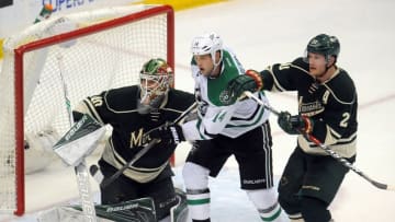 Apr 24, 2016; Saint Paul, MN, USA; Minnesota Wild defenseman Ryan Suter (20) defends against Dallas Stars forward Jamie Benn (14) in front of goalie Devan Dubnyk (40) during the third period in game six of the first round of the 2016 Stanley Cup Playoffs at Xcel Energy Center. The Stars win 5-4 over the Wild. Mandatory Credit: Marilyn Indahl-USA TODAY Sports