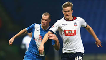 BOLTON, ENGLAND - JANUARY 19: James Constable of Eastleigh and Rob Holding of Bolton Wanderers compete for the ball during the Emirates FA Cup Third Round Replay match between Bolton Wanderers and Eastleigh at Macron Stadium on January 19, 2016 in Bolton, England. (Photo by Clive Brunskill/Getty Images)