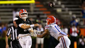 Florida Gators quarterback Graham Mertz (15) passes while under pressure by Florida Gators outside linebacker T.J. Searcy (19) during the second half of the University of Florida Orange & Blue game at Ben Hill Griffin Stadium in Gainesville, FL on Thursday, April 13, 2023. Orange defeated Blue 10-7. [Doug Engle/Gainesville Sun]Ncaa Football Orange And Blue Game